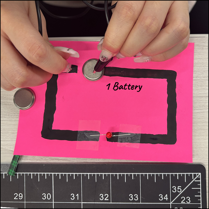 I used alligator clips on the paper with conductive paint. 1 battery was used and the LED was dim.