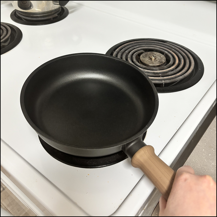 The sound of the pan being put on the stove.